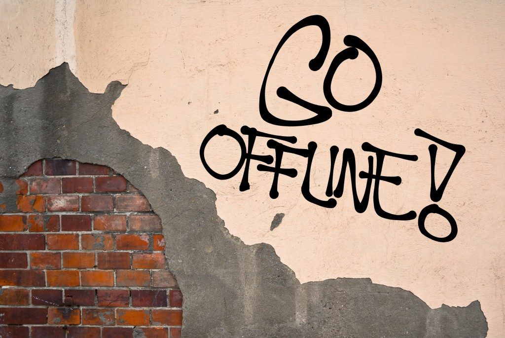 Go Offline - handwritten graffiti sprayed on the wall 