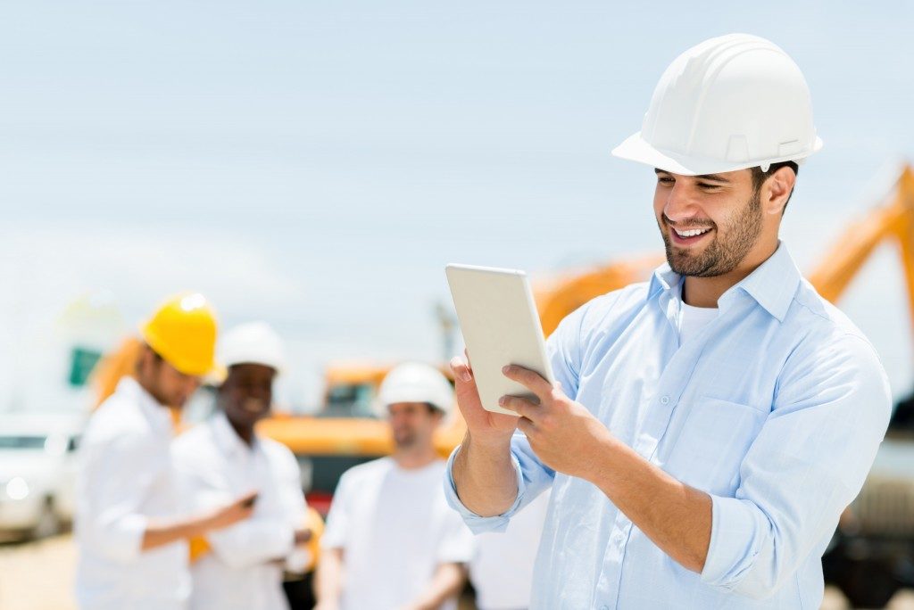 construction workers using GPS system to track the site