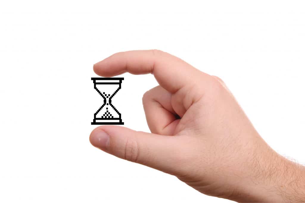 Hand holding a cartoon image of an hourglass