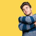 Man hugging himself in self-esteem concept