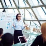 a woman presenting at a meeting