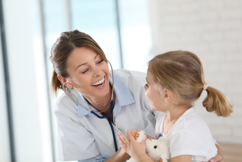 A pediatrician interacting with a child